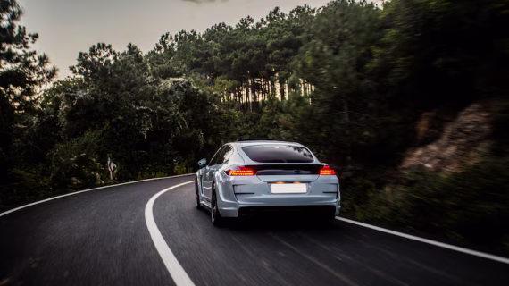 sport-car-with-black-white-autotuning-driving-forest_114579-4076