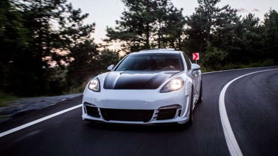 white-sport-car-with-black-autotuning-driving-road_114579-4071